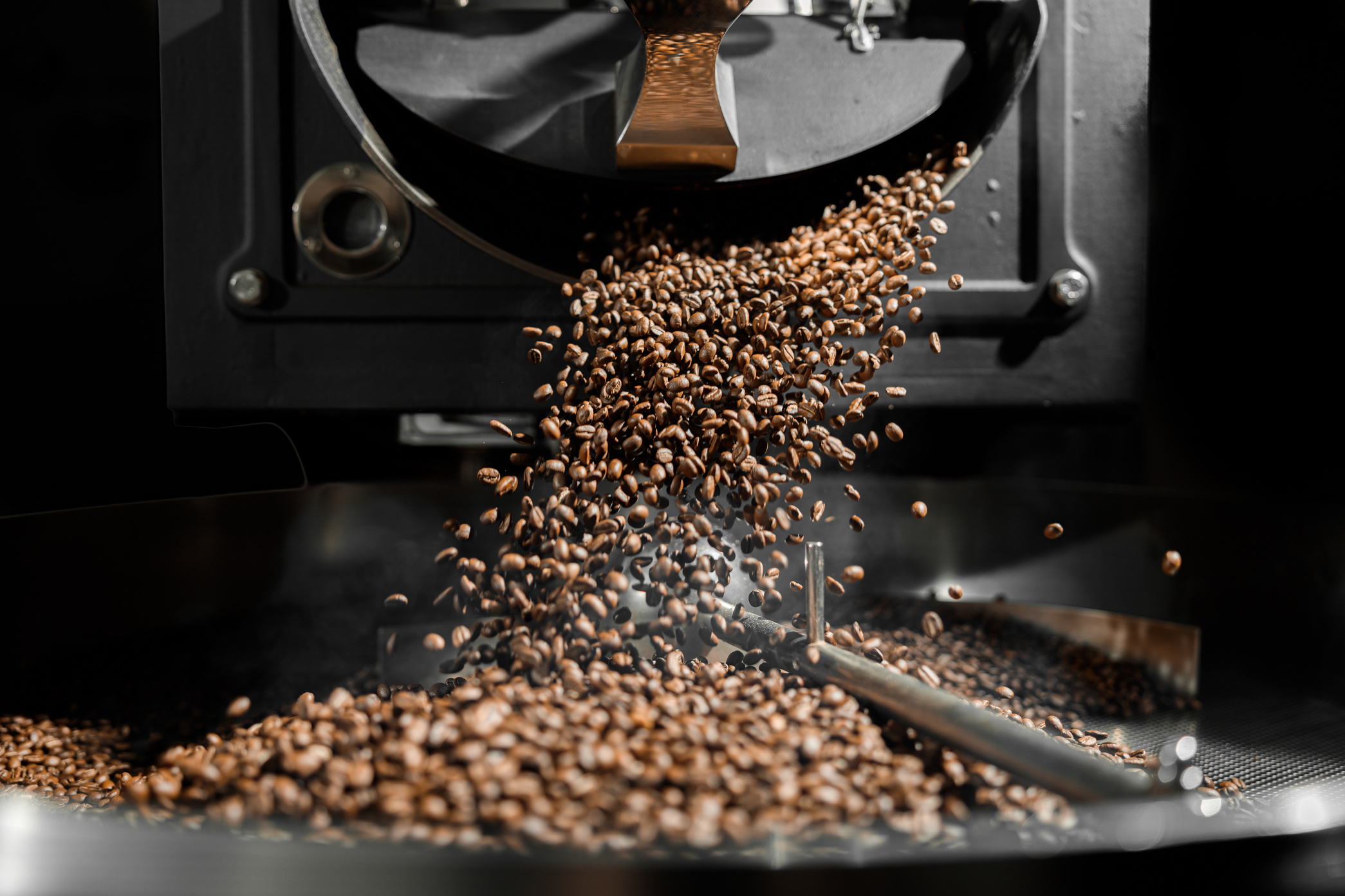 Coffee Processing. Roastery, Roasting Machine and Fresh Beans